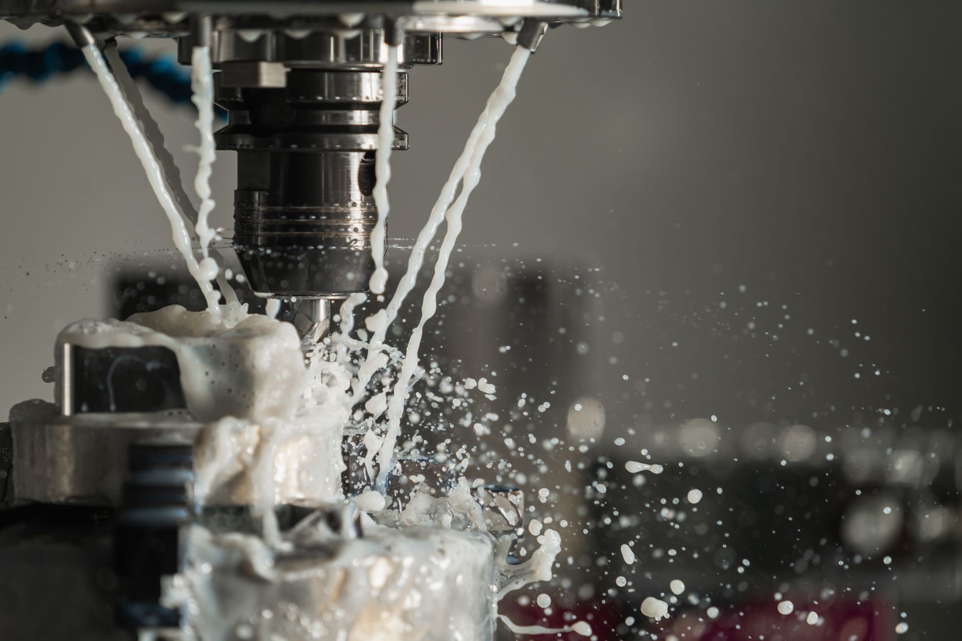 Cutting fluid flooding a CNC cutter mid-cut in the tool room