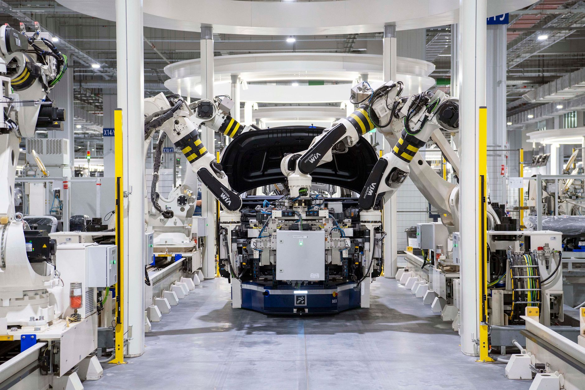 Robotic cells running an automated assembly line inside a modern factory