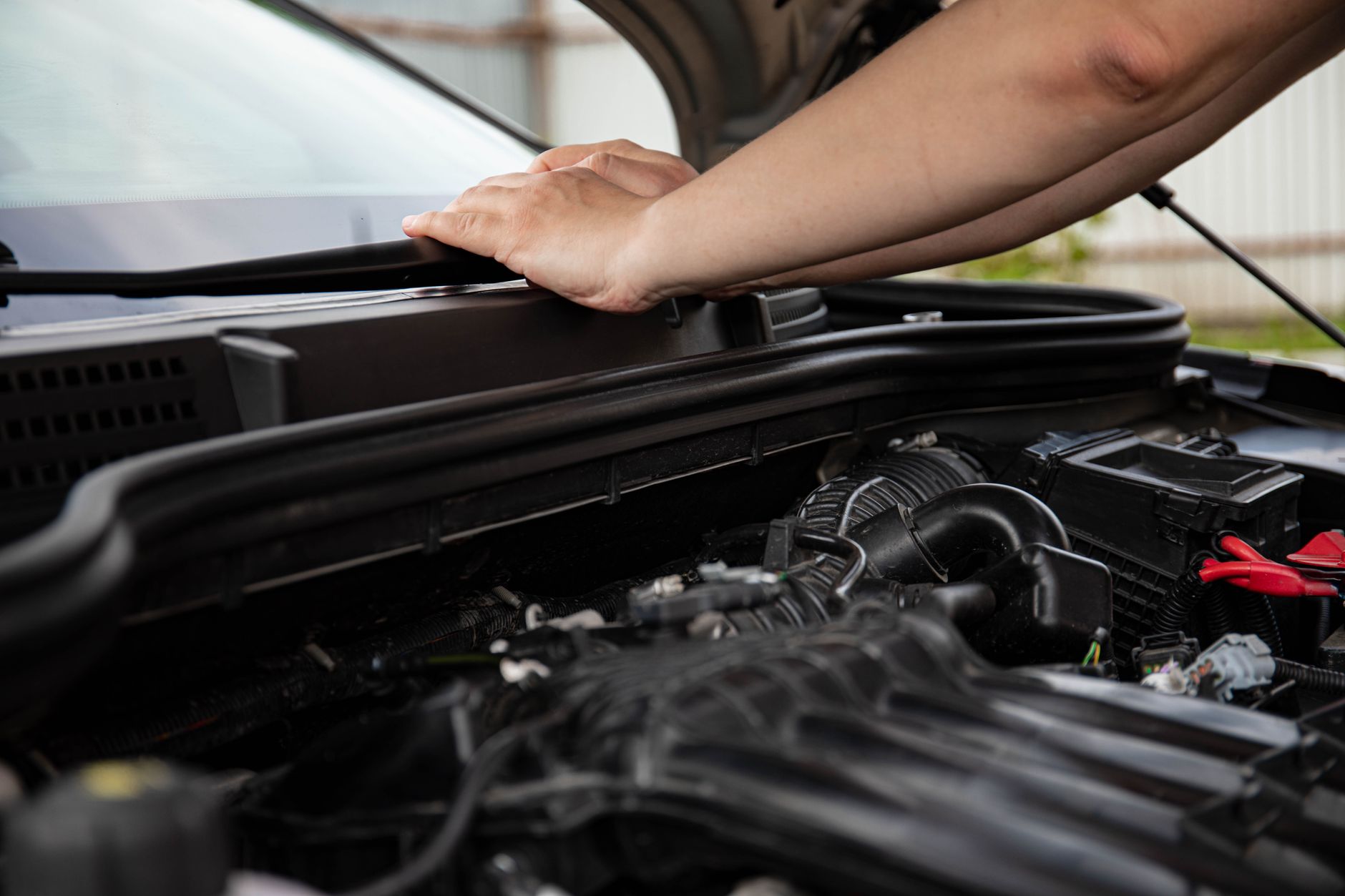Black moulded plastic components in a vehicle engine bay